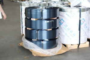 Juhong workshop production of blue steel strapping in jumbo coil winding. High tensile steel strapping for large volume industrial packaging applications.