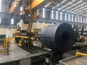 Factory application of high-tensile blue and waxed steel strapping on hot-rolled coils, meeting ASTM D3953 standards by Juhong Packing