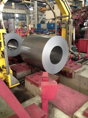 Green PET Strapping securing heavy metal coils and steel wire for stable industrial storage and shipping