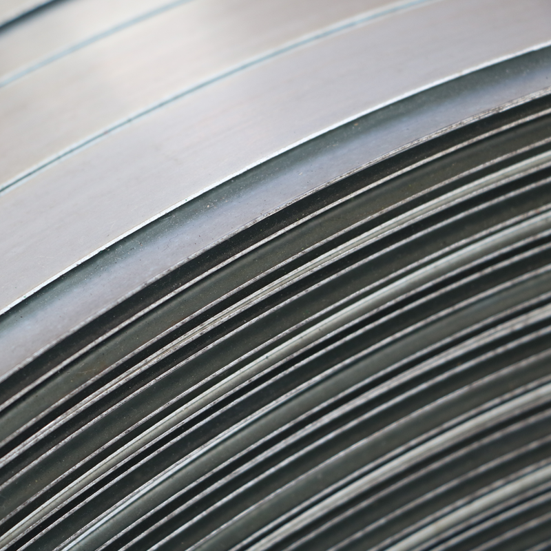 Detailed view of zinc coated high tensile steel strapping surface (1020 MPa) in jumbo oscillated winding, meeting international EN 13246 and US ASTM requirements for industrial supply chain safety.
