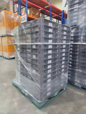 High-clarity stretch film wrapping fruit containers to ensure security during handling
