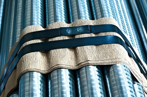 Blue waxed steel strapping securing steel pipe bundles for shipmen