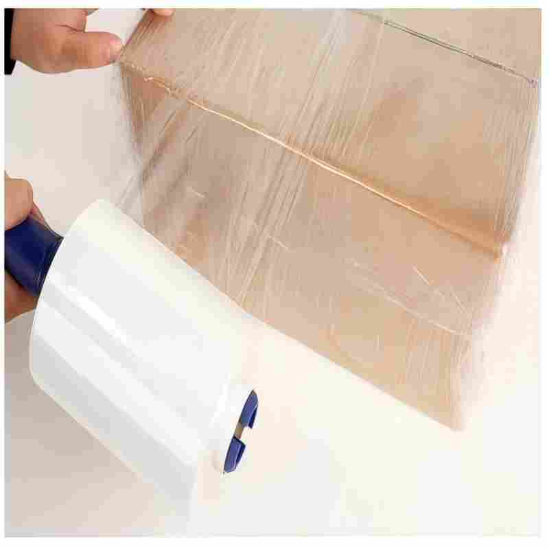 Hand-held mini stretch film being used to wrap and bundle a cardboard ex