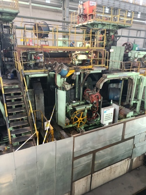 High-tensile steel strapping from Juhong Packing Materials running through a Packway industrial strapping machine for automated packaging solutions.