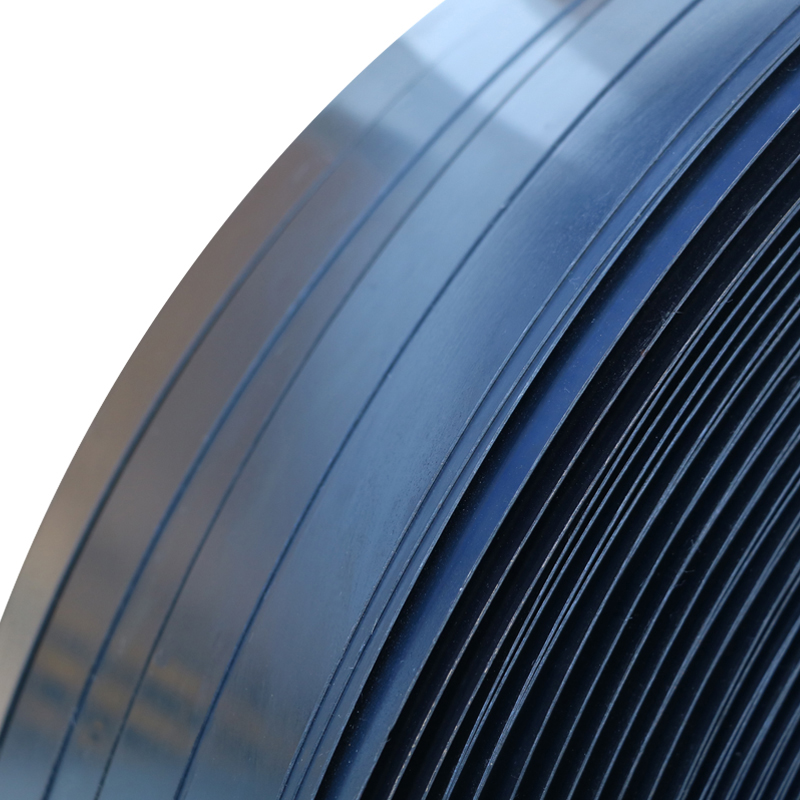 Close-up of blue tempered steel strapping showing safety deburred edges for secure industrial packaging