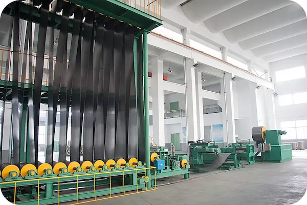 Wide steel coil being slit into narrow strips for steel strapping
